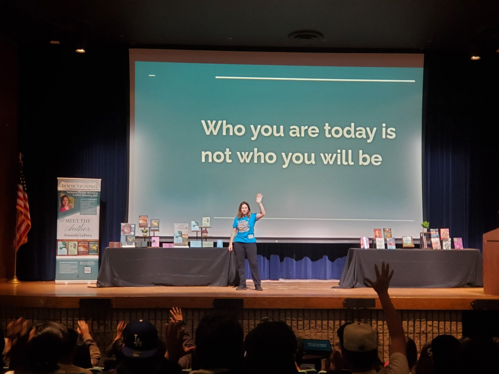 Amanda LaPera speaking on a large stage.